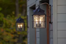 Carriage style lights on both sides of a garage door.